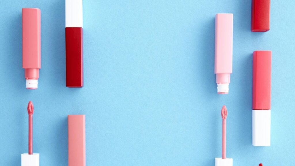 Lip glosses on a sky blue background